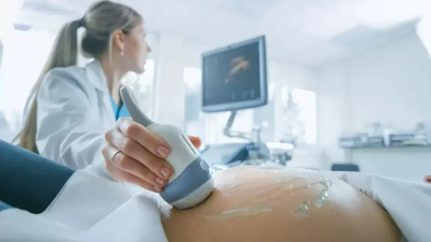 female-doctor-performing-ultrasound-on-pregnant-woman-in-the-hospital