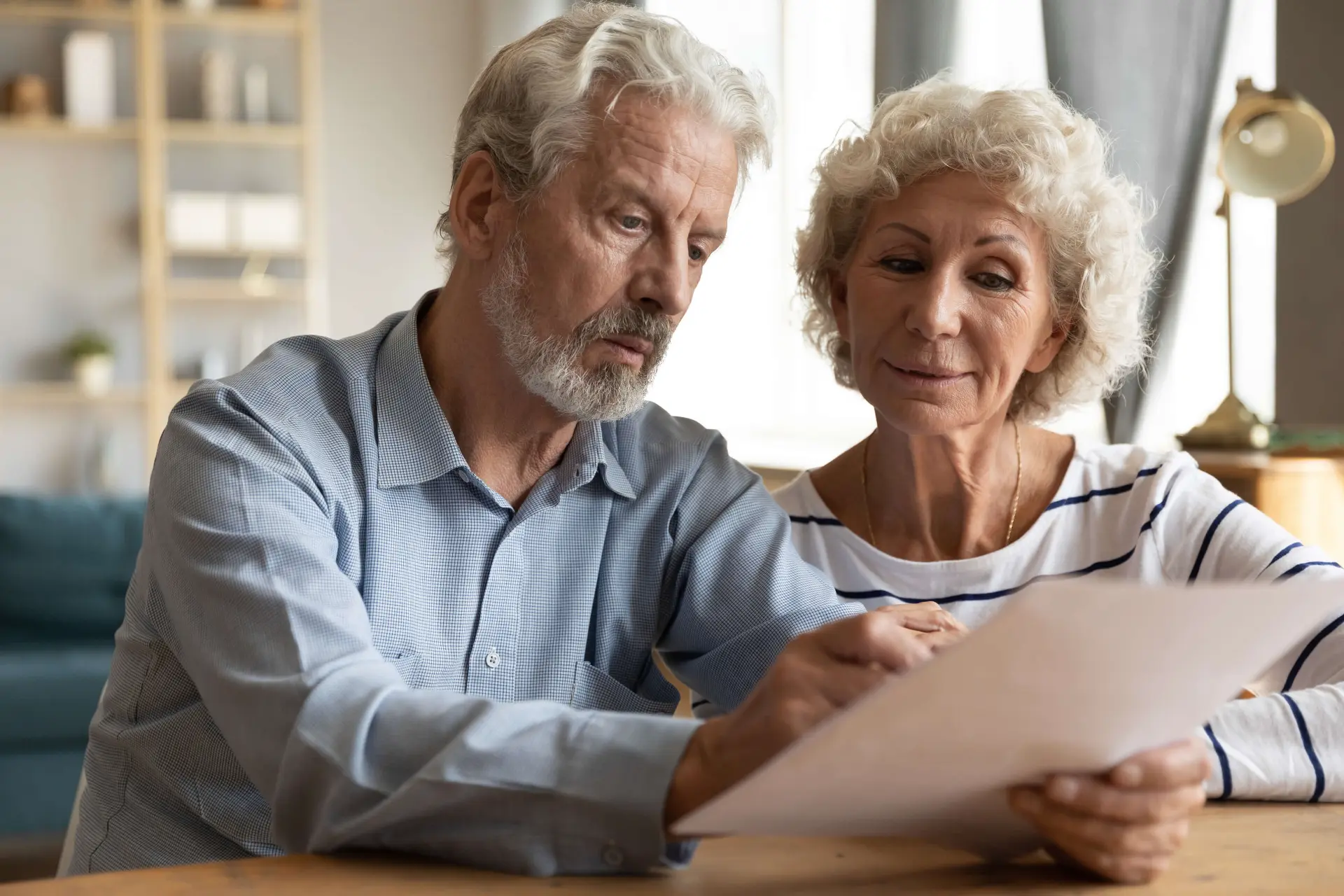 a man and woman look over a legal document as they consider their options after an accident