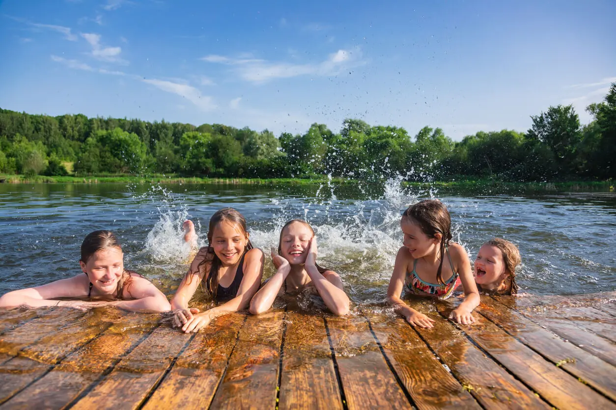 children enjoying summer holidays at a lake