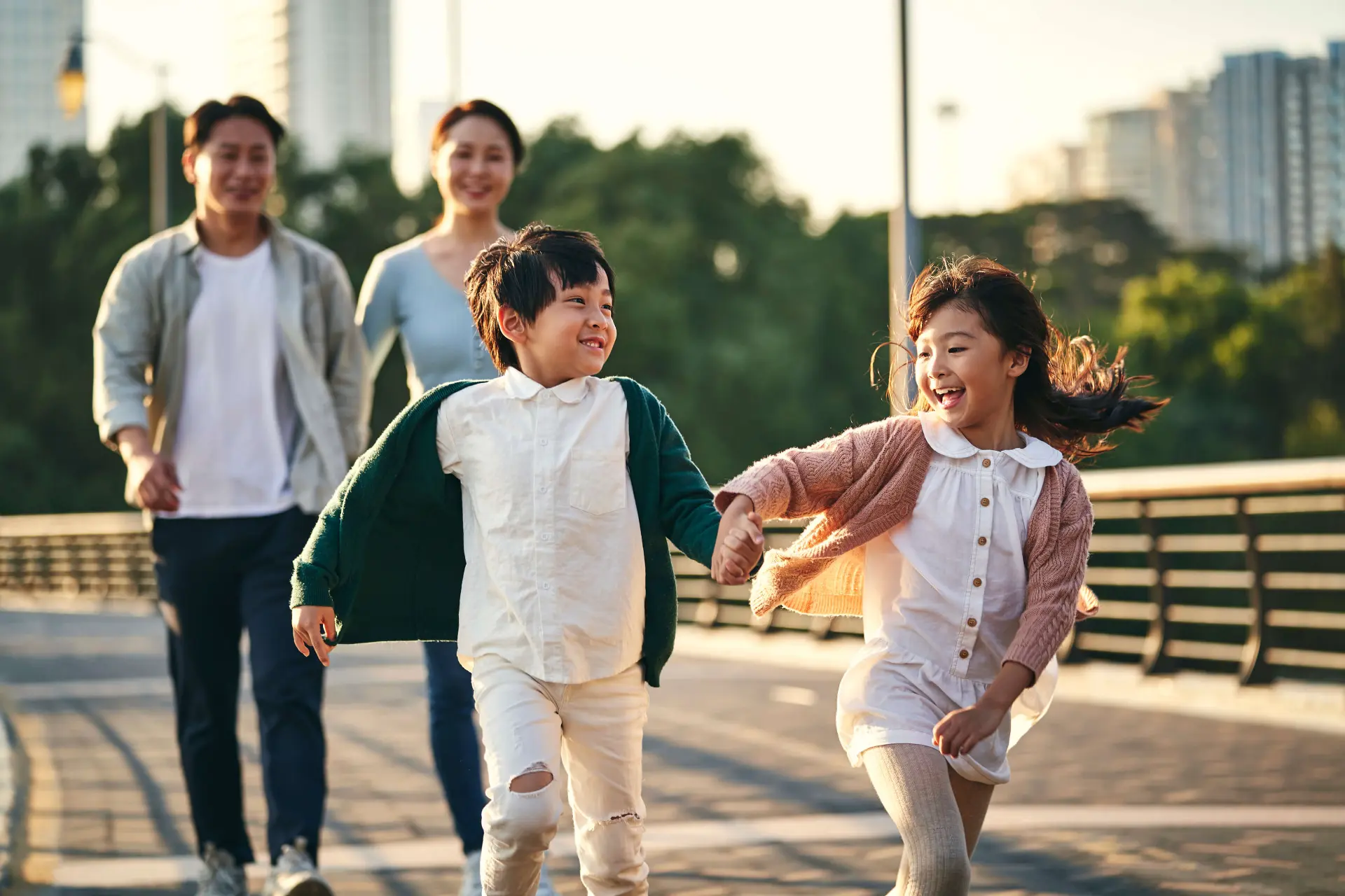 a Chinese Canadian family of four walks along a boardwalk