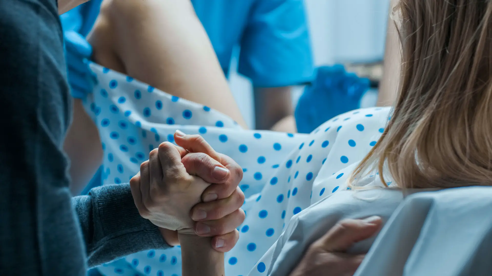 a woman in labour holds onto her partner