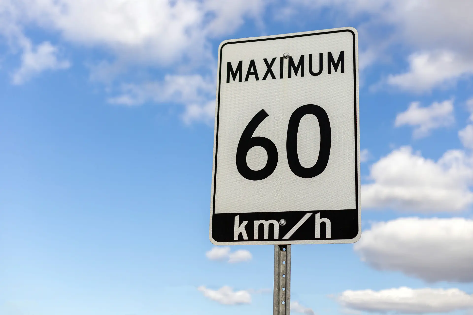 a speed limit sign on a highway