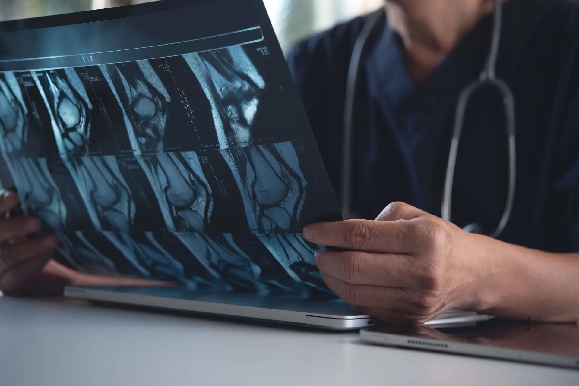 a radiologist examines a patient's scan