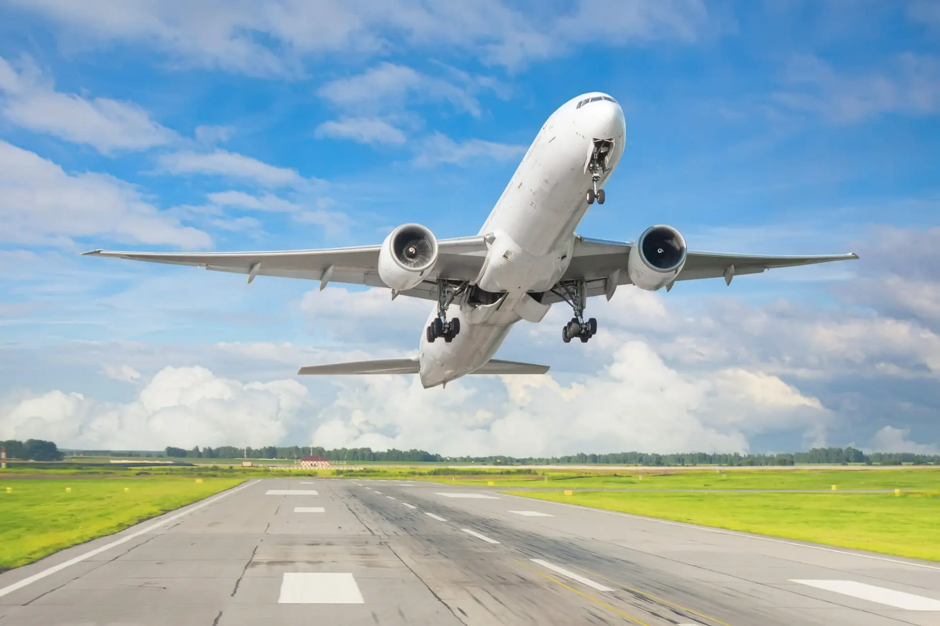 a plane taking off from the tarmac on an outbound flight a plane taking off from the tarmac on an outbound flight