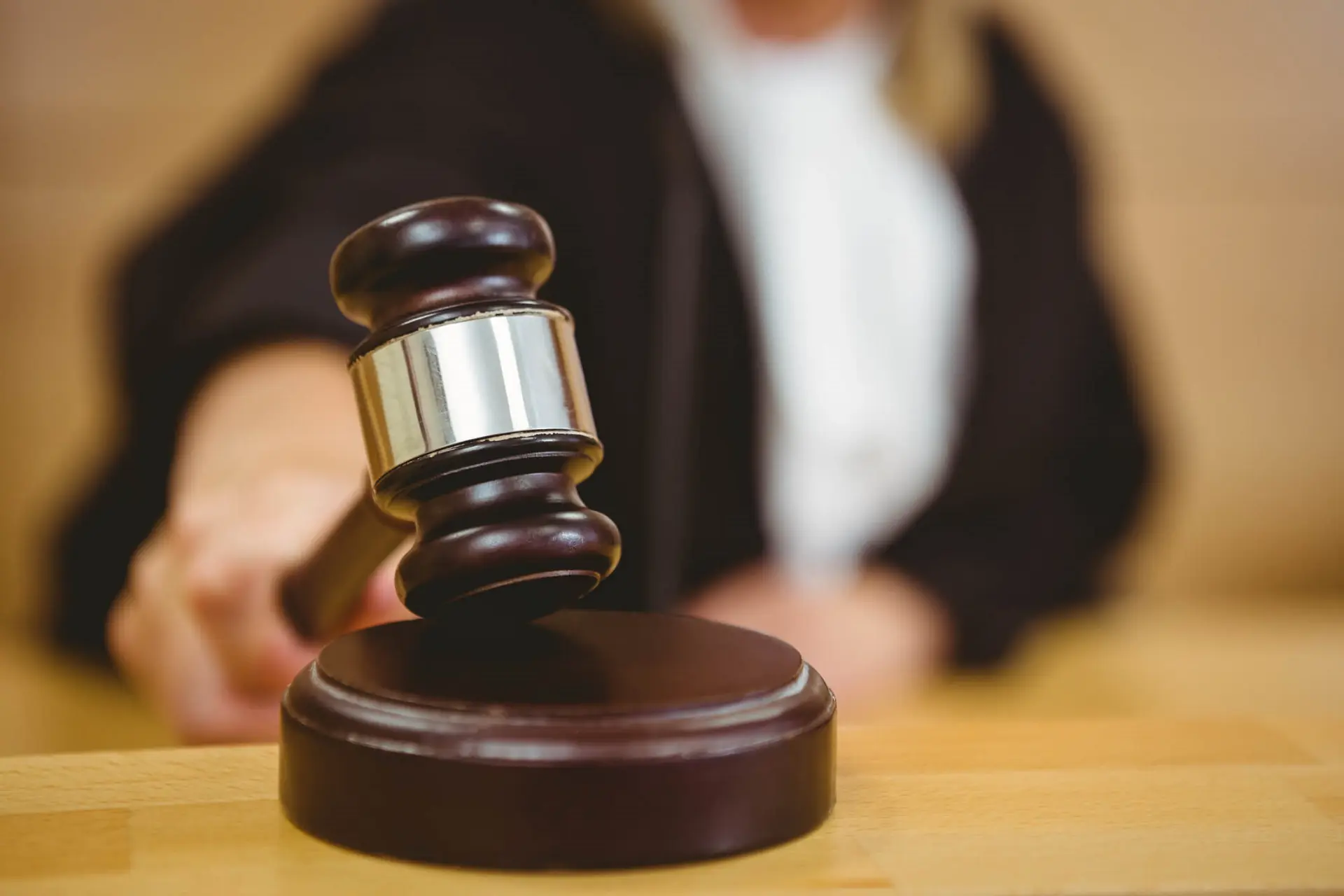 a justice is about to bang a gavel on a block in a court room