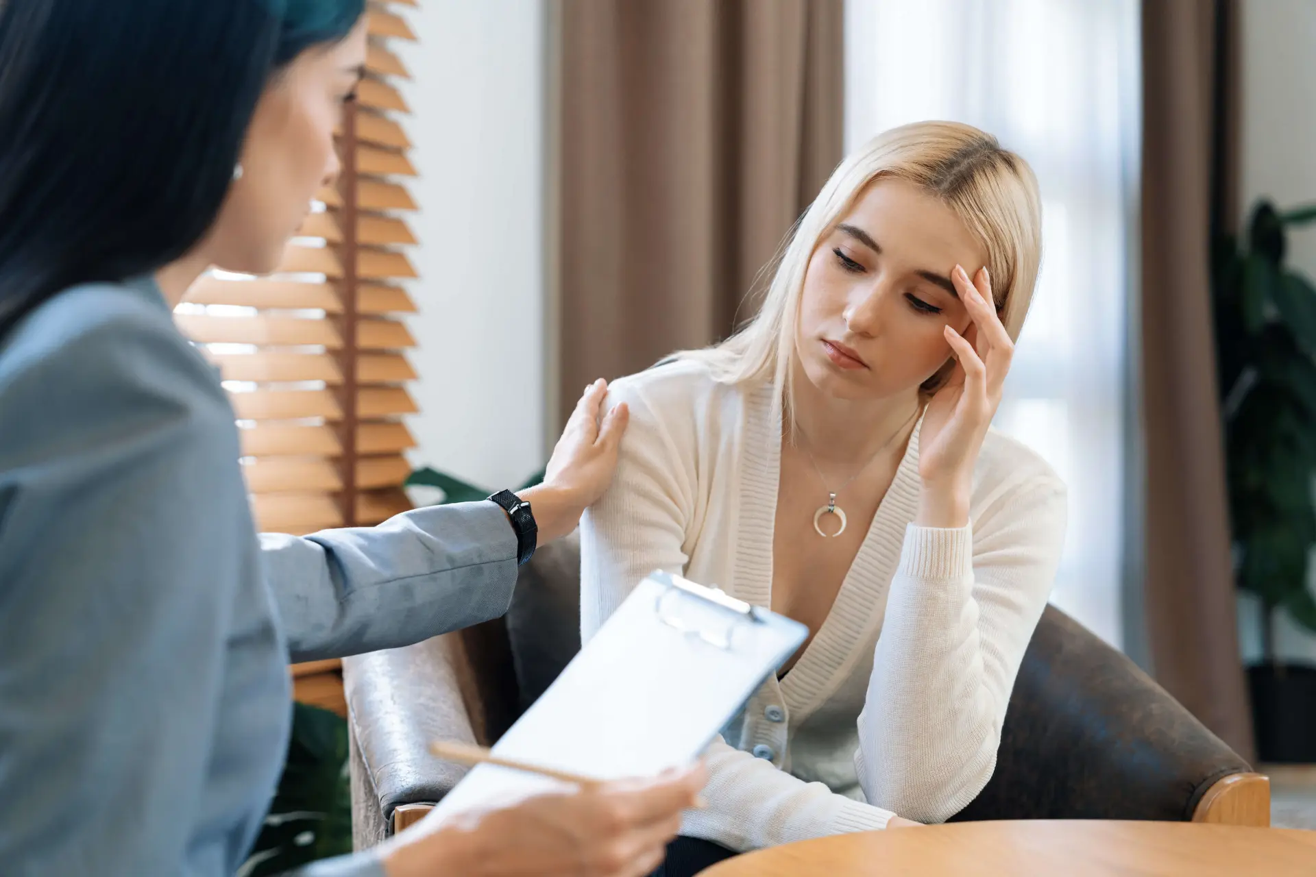 A lawyer comforts their client who is considering their legal options