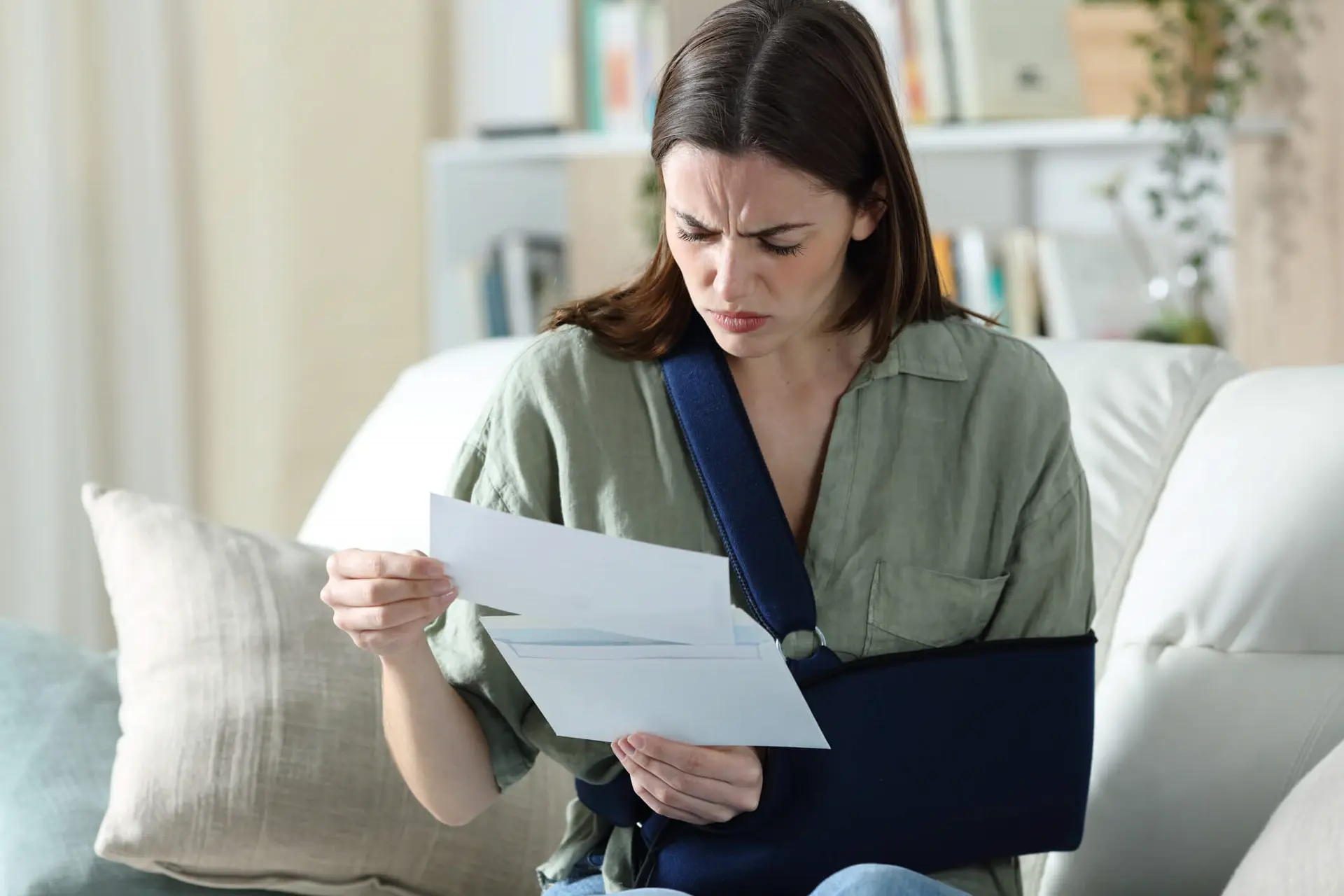 a woman reviews paperwork from her insurance company following a motor vehicle accident