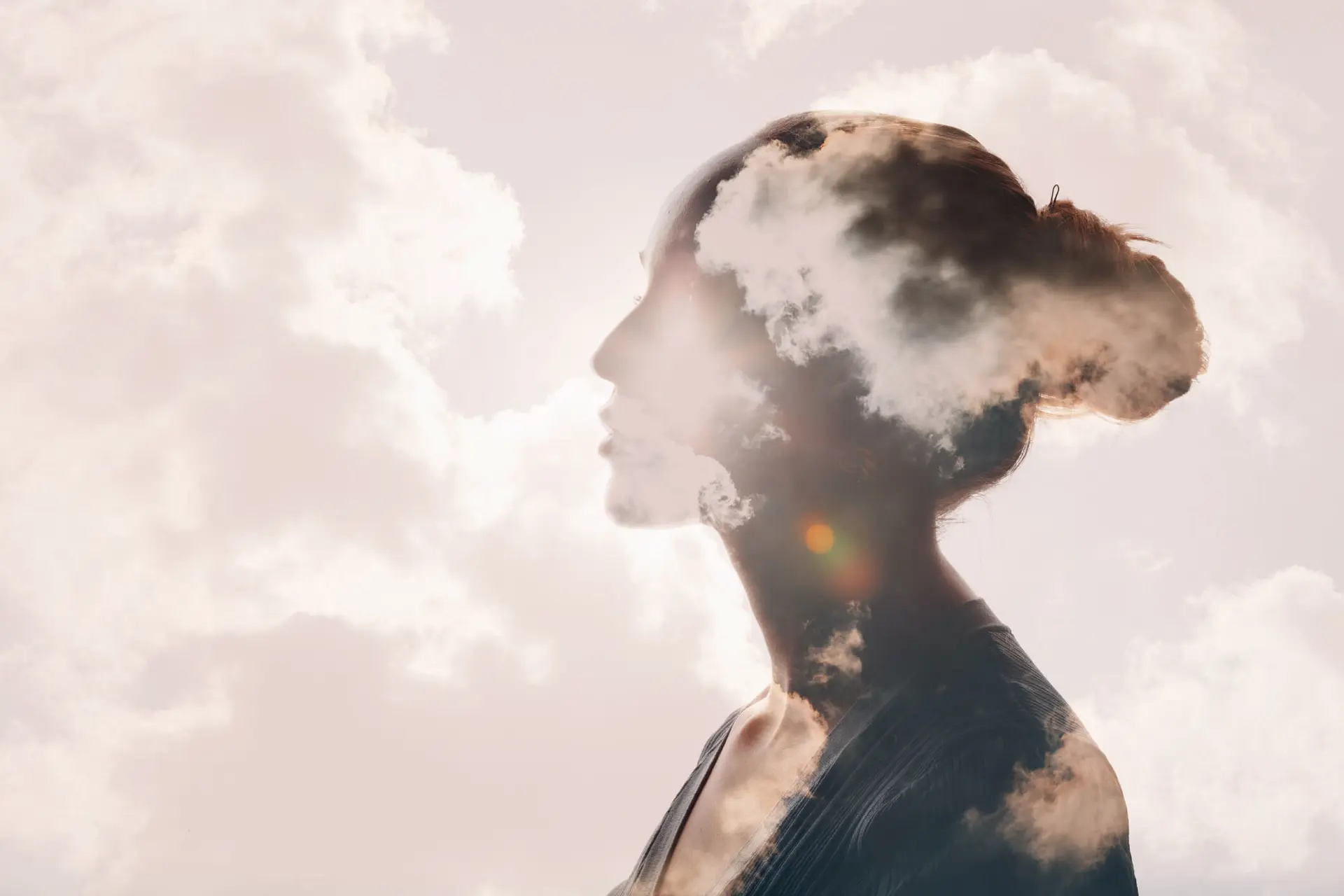 a woman is superimposed in the clouds to reflect mental health struggles