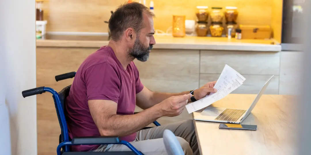 a person reads through paperwork about the Canadian Disability Tax Credit