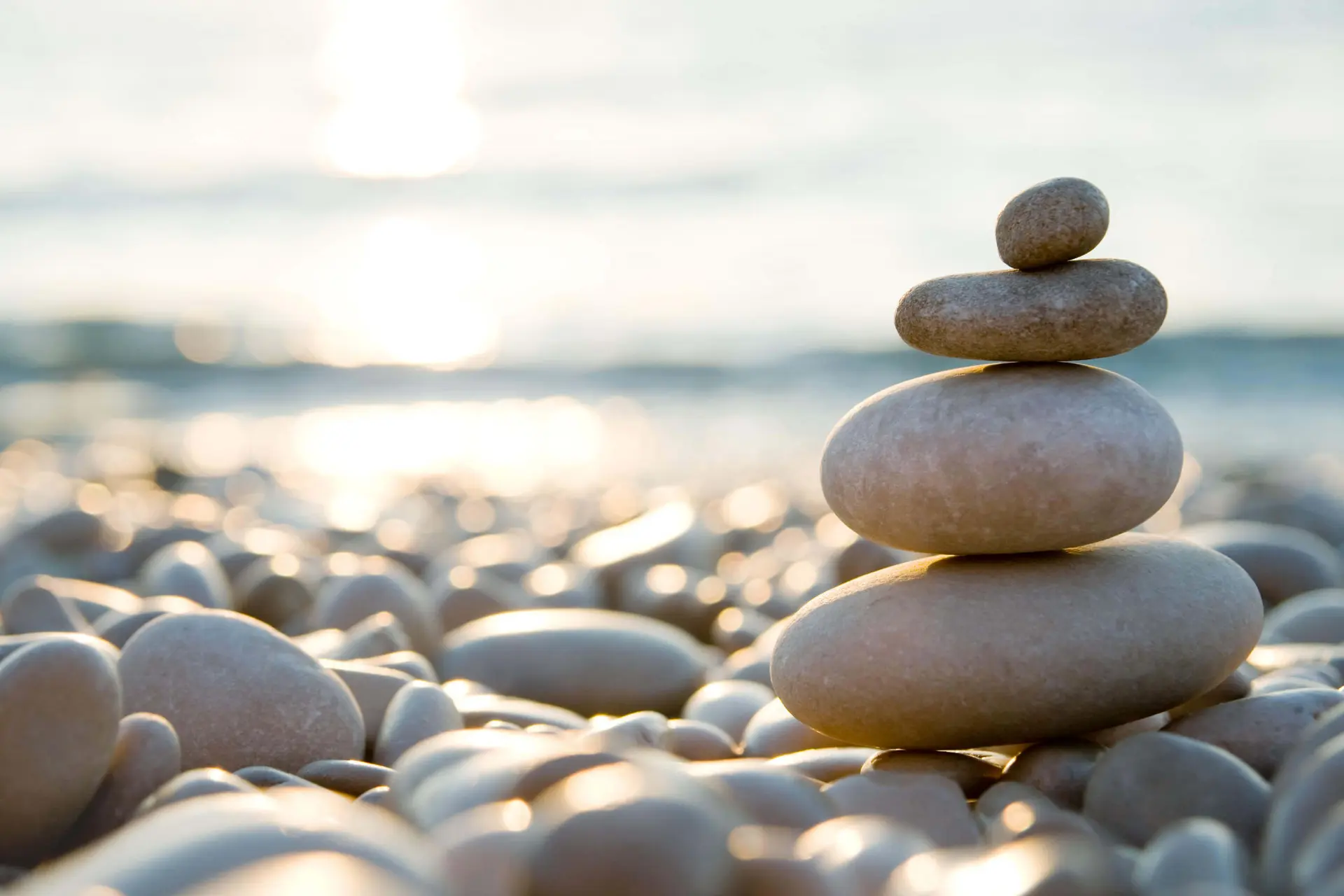 Balanced stones on a beach - concept of Compassion and Zen Balanced stones on a beach - concept of Compassion and Zen