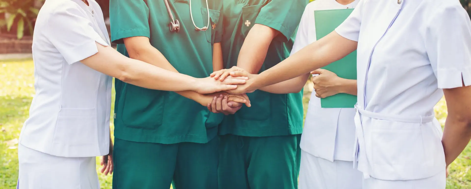 doctors, nurses place hands on top of each other, together concept
