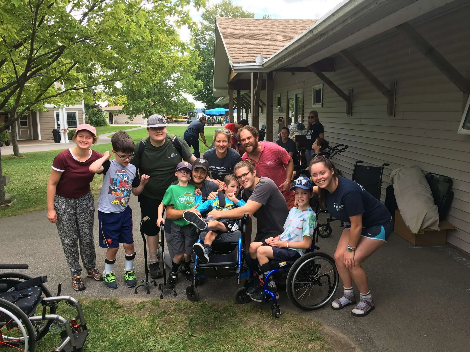 group of cheerful physically disabled children at camp looking at the camera