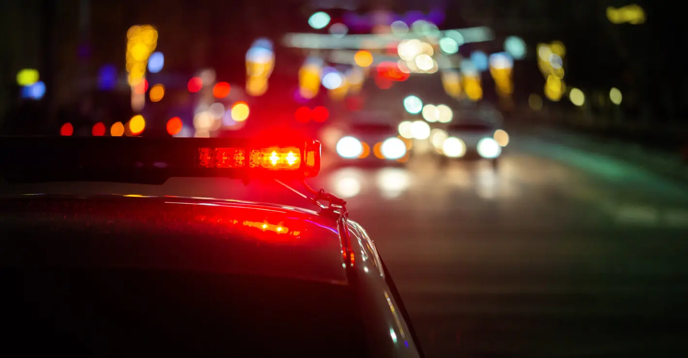 police car lights at night in the city with background blur