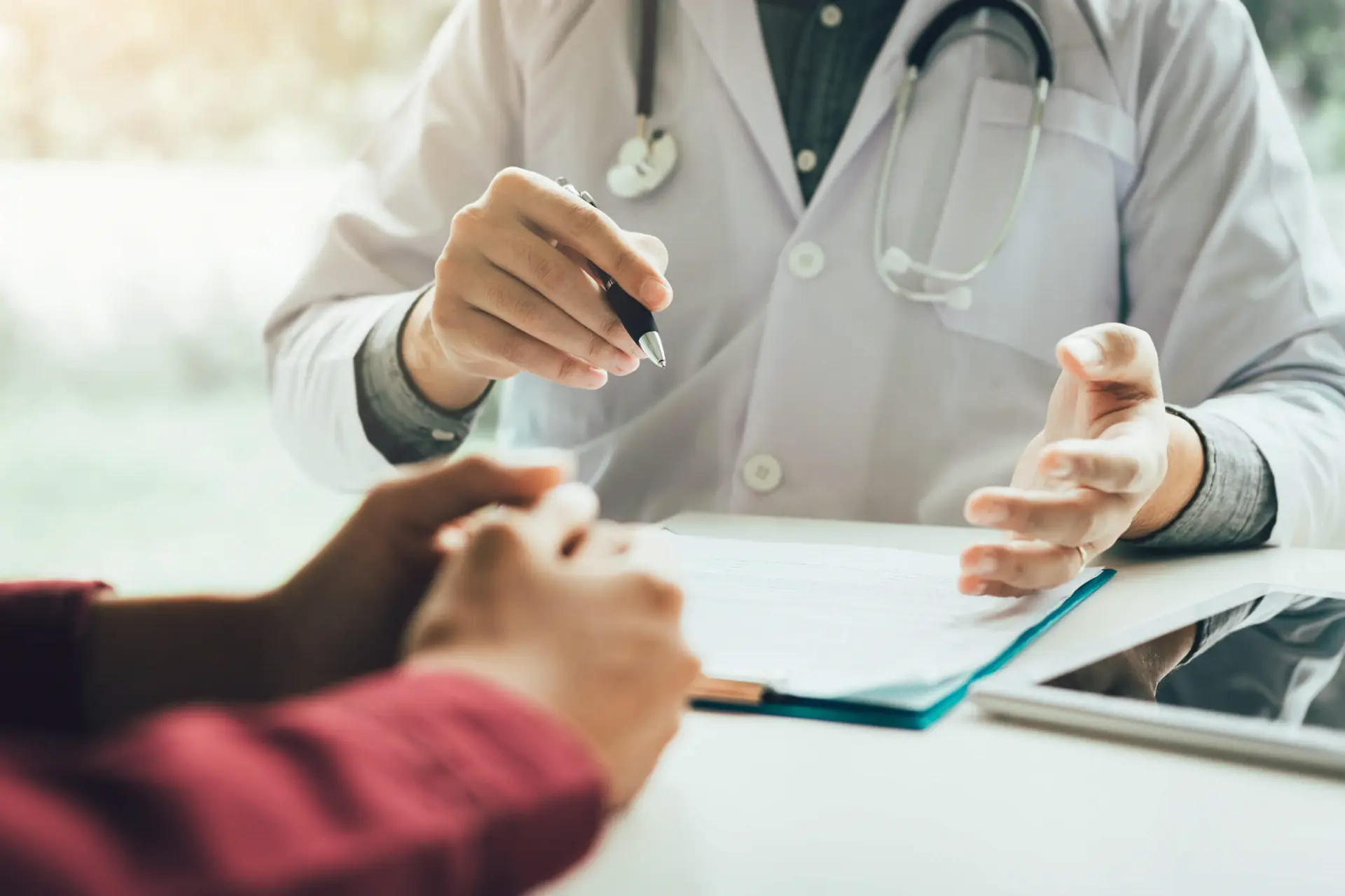 Male doctor talking to a female patient about treatment