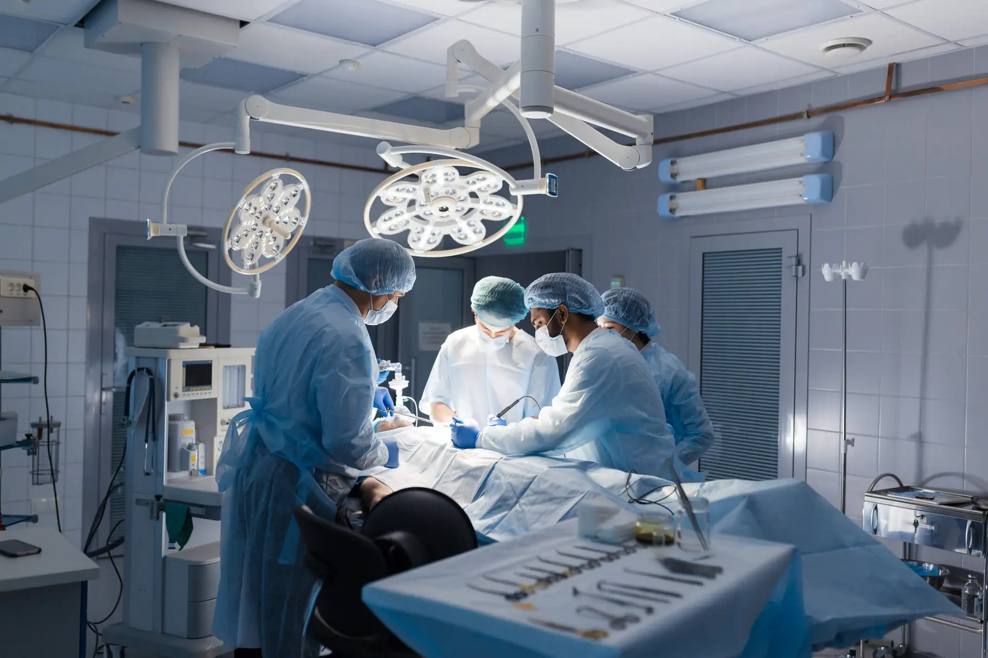 Team of Surgeons concentrating on a patient during a surgery at a hospital.