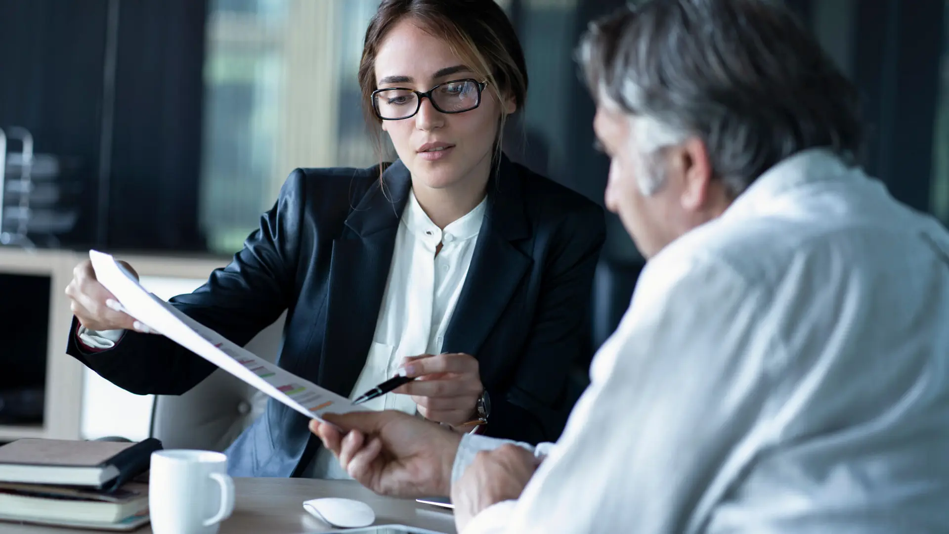 Business woman reviewing a document with a client in her office